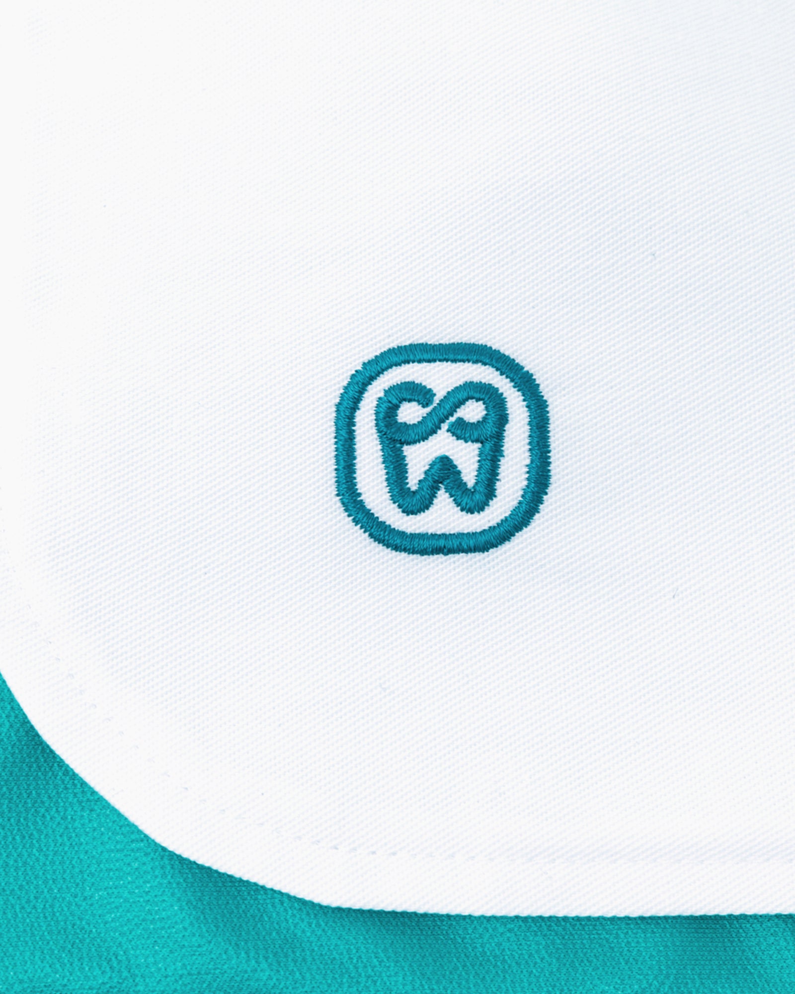 Close-up of some white material with the DentalEcoBibs logo.